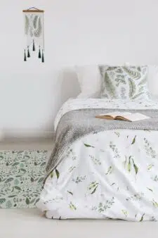 green-nordic-leaves-pillow-on-bed